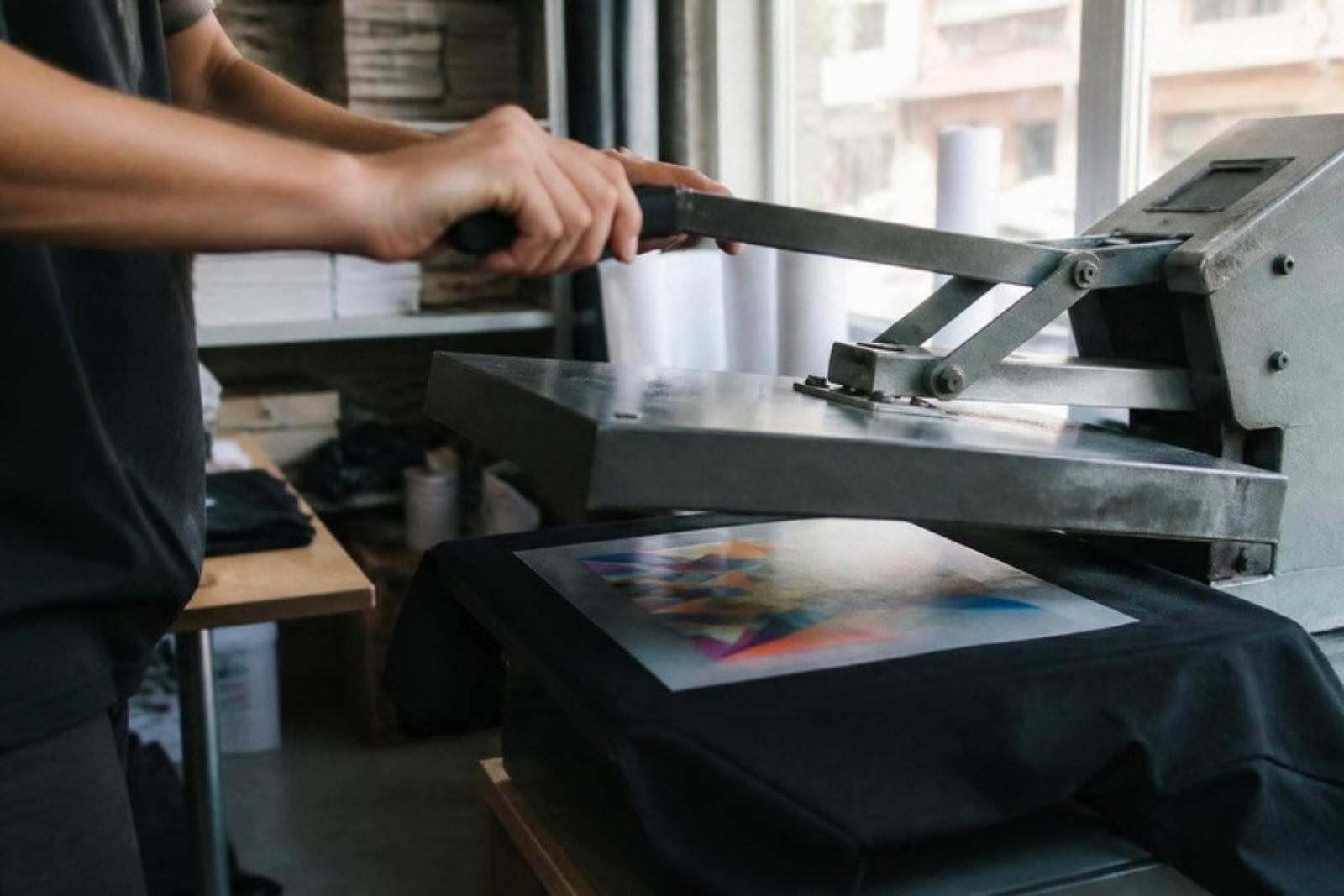 Heat press applying a full-color DTF transfer to a t-shirt